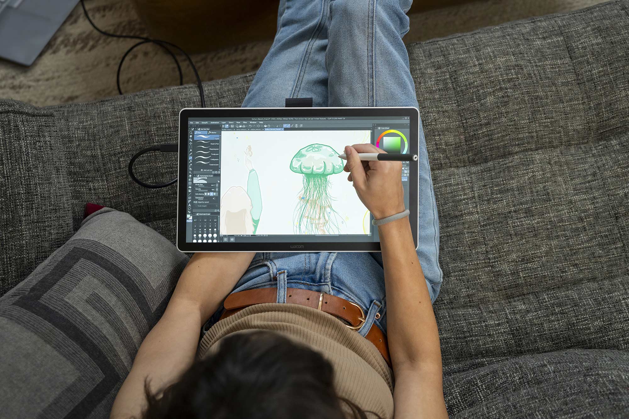 Wacom One 14 drawing display on lap.